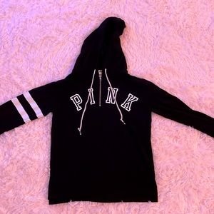 Black, light material hoodie with zipper up top.